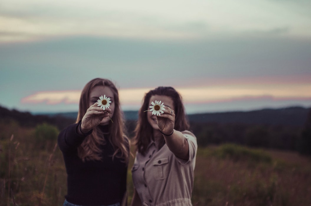 Girls holding flowers up